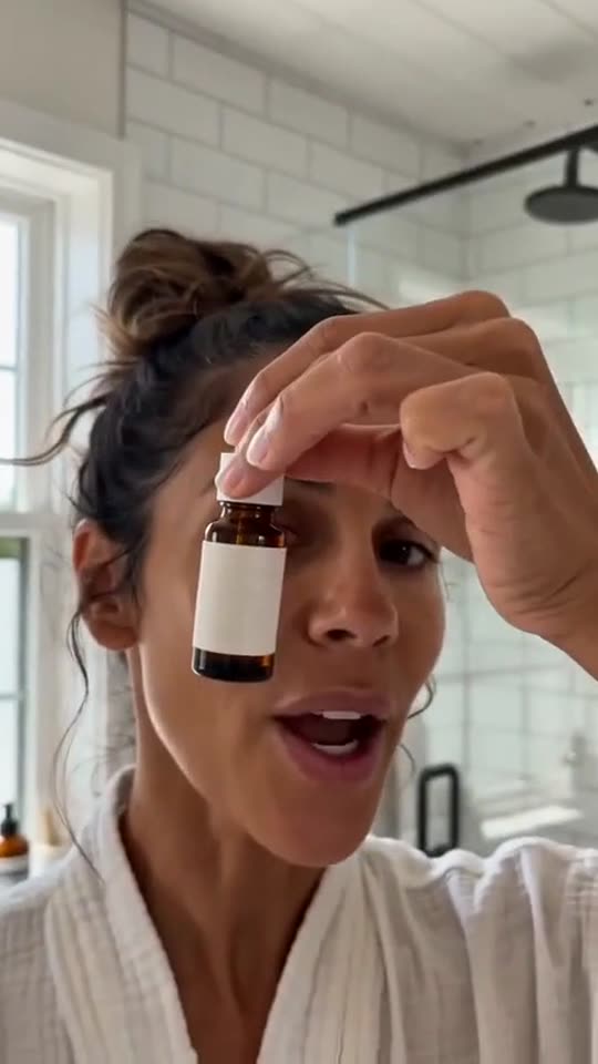Morning serum routine, two drops, talking to camera. Product is made up.